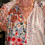 Woman wearing a floral blouse with a blurred background