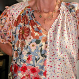 Woman wearing a floral blouse with a blurred background