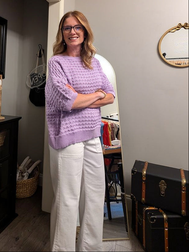 Woman standing in a room with furniture and decor